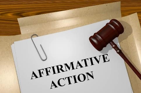 A gavel beside a paper clipped document headed Affirmative Action